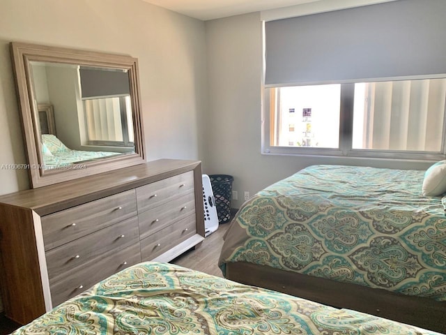 bedroom with dark hardwood / wood-style flooring