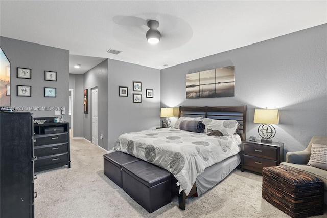 bedroom with light carpet and ceiling fan