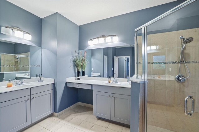 bathroom featuring tile floors, an enclosed shower, and double sink vanity