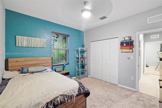 bedroom with tile floors, a closet, and ceiling fan