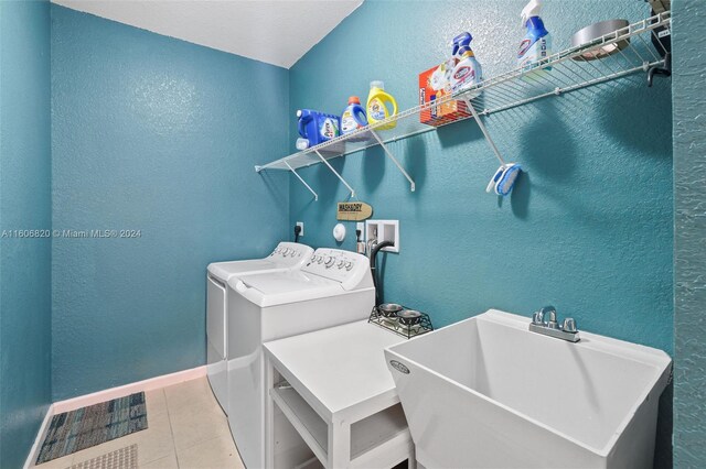 washroom featuring tile floors, hookup for an electric dryer, hookup for a washing machine, independent washer and dryer, and sink