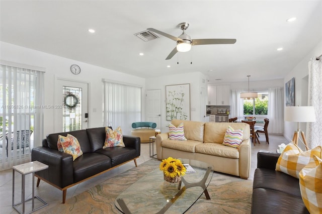 living room with light tile patterned flooring and ceiling fan