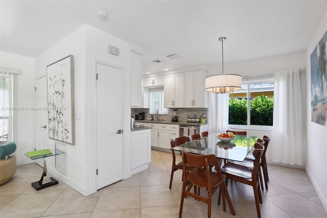 dining room featuring light tile patterned floors and sink