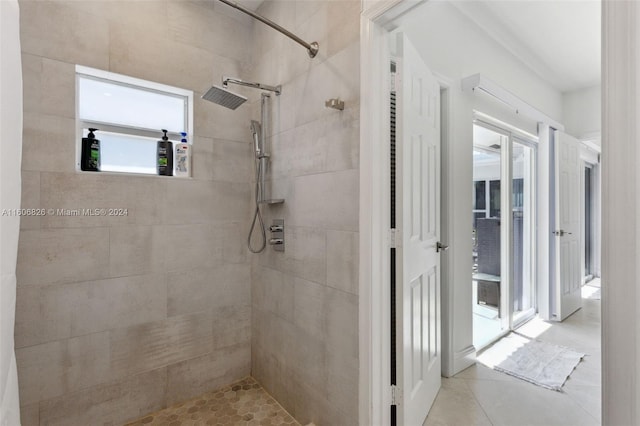 bathroom with a tile shower and tile patterned floors