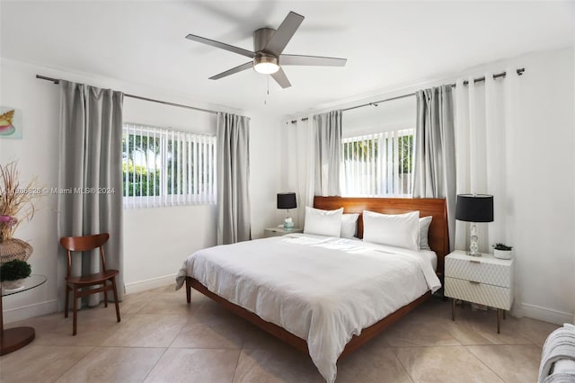 bedroom featuring multiple windows, tile patterned flooring, and ceiling fan