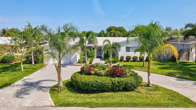 view of front facade with a front yard and a garage