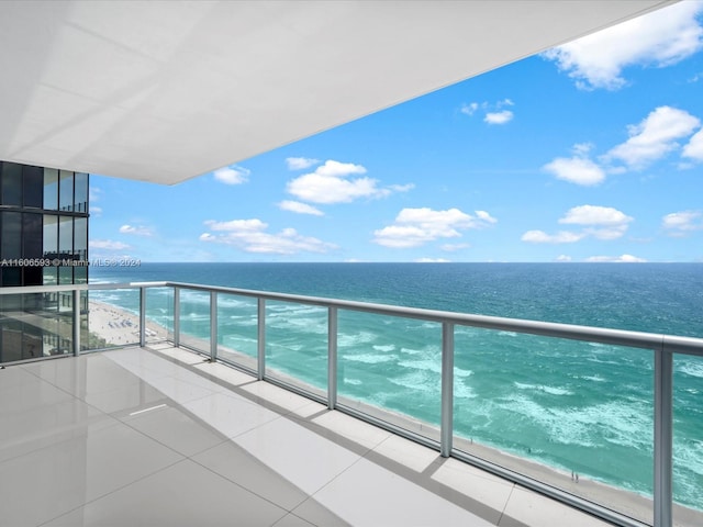 balcony with a water view and a beach view