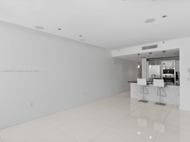 tiled living room featuring sink