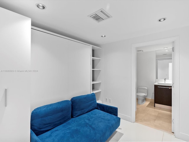 living area with sink and light tile patterned floors