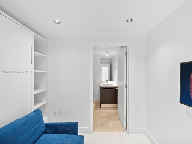 walk in closet with sink and light tile patterned flooring