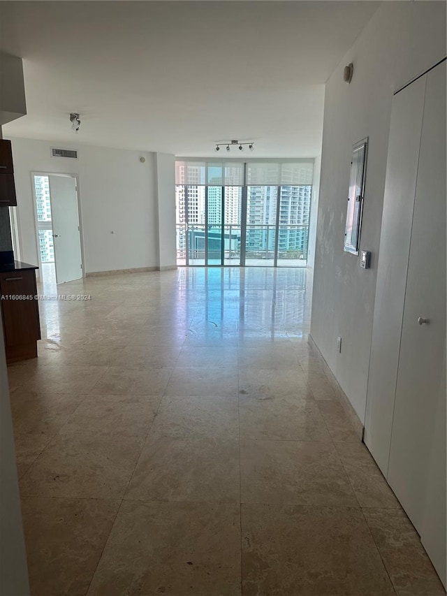 unfurnished room featuring tile flooring and track lighting