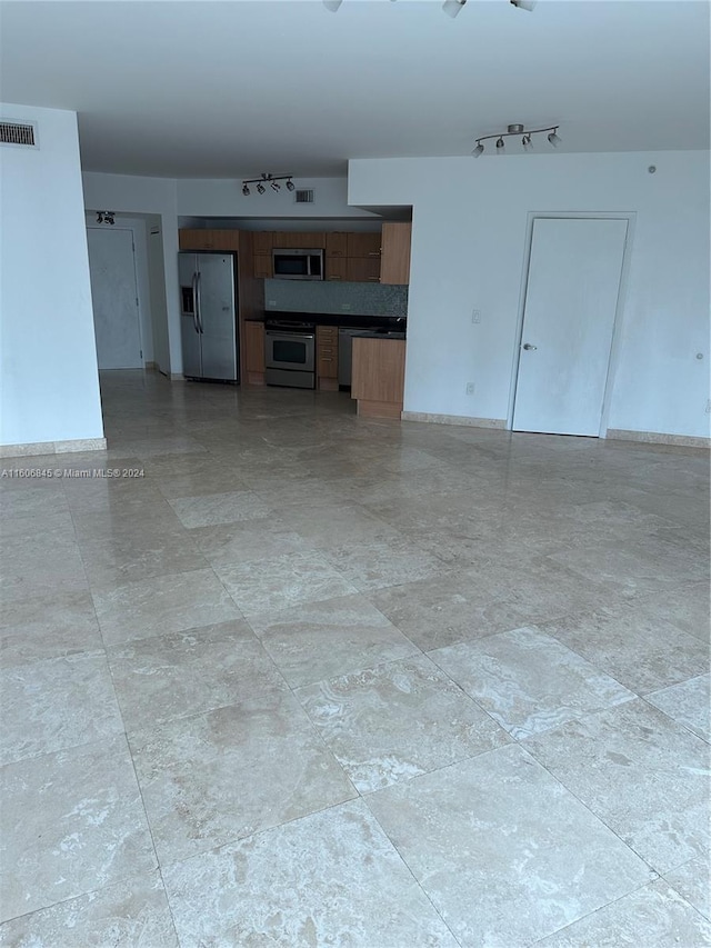 unfurnished room with rail lighting and visible vents