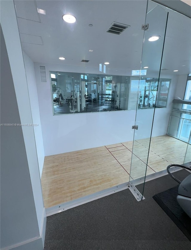 hallway with wood-type flooring