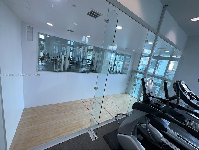 exercise room featuring hardwood / wood-style floors