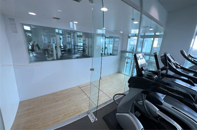 workout area with wood-type flooring