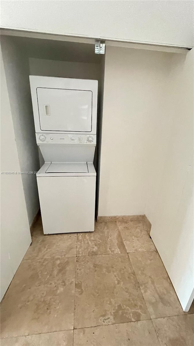 clothes washing area featuring stacked washing maching and dryer