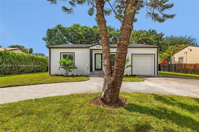 mediterranean / spanish house with a front yard and a garage