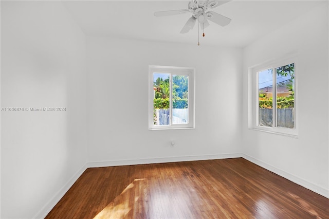 spare room with wood-type flooring, ceiling fan, and a wealth of natural light