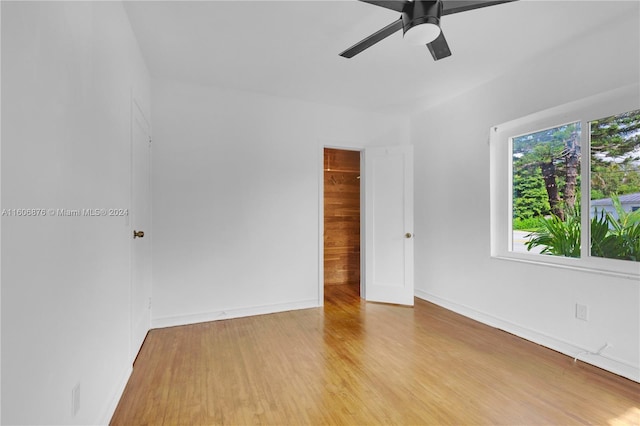 empty room with ceiling fan and light hardwood / wood-style floors