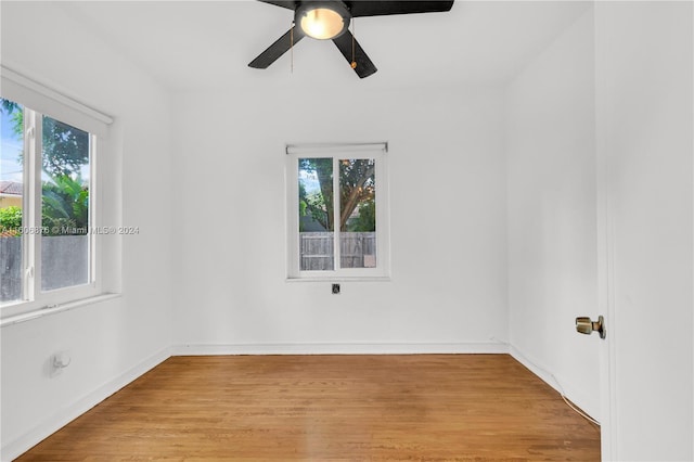 spare room with ceiling fan and light wood-type flooring