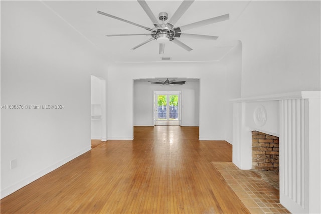 unfurnished living room with wood-type flooring and ceiling fan