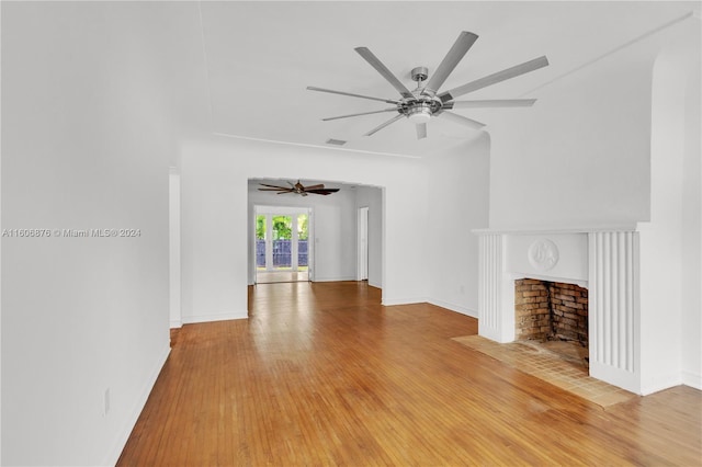 unfurnished living room featuring ceiling fan and hardwood / wood-style floors