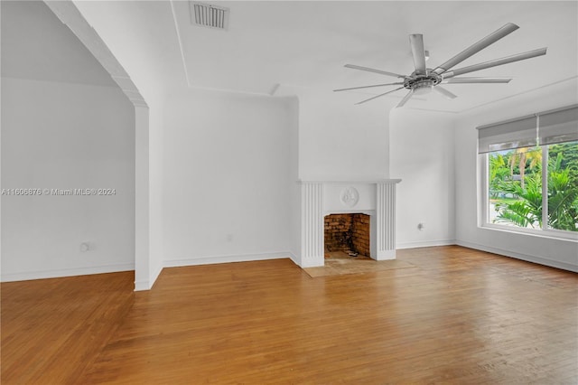 unfurnished living room with light wood-type flooring and ceiling fan