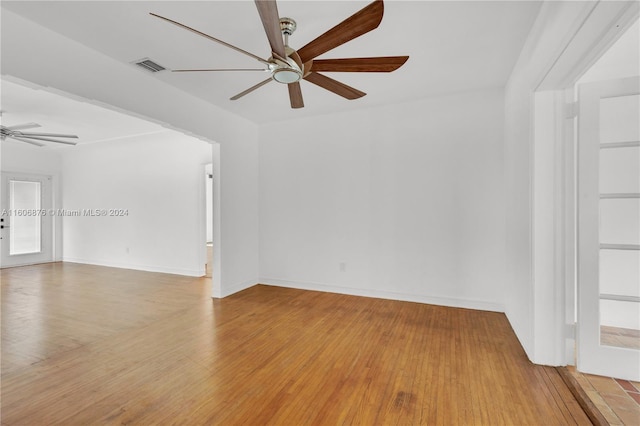 empty room featuring ceiling fan and hardwood / wood-style floors