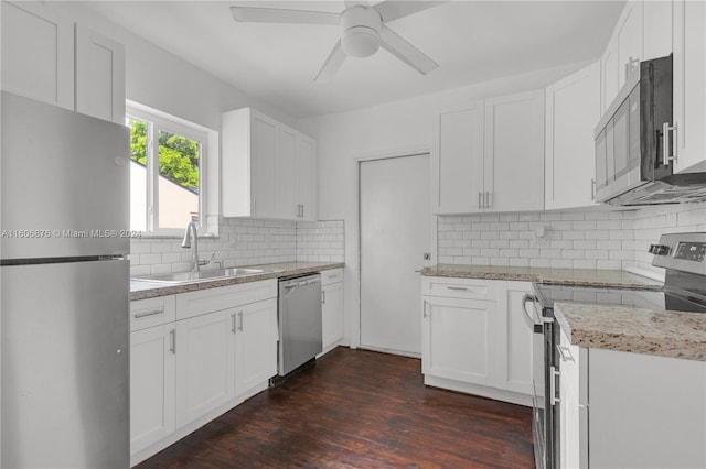 kitchen featuring stainless steel appliances, tasteful backsplash, white cabinetry, ceiling fan, and sink