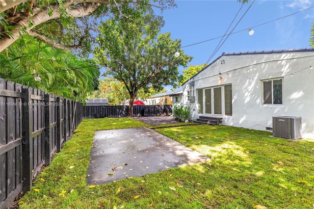 view of yard featuring a patio and central AC unit