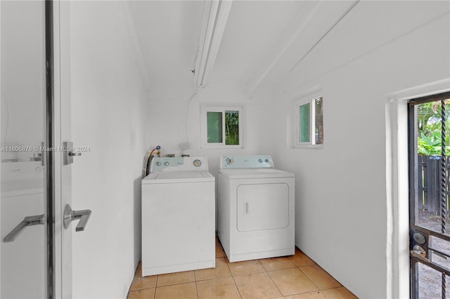 laundry room with washer and clothes dryer and light tile patterned floors