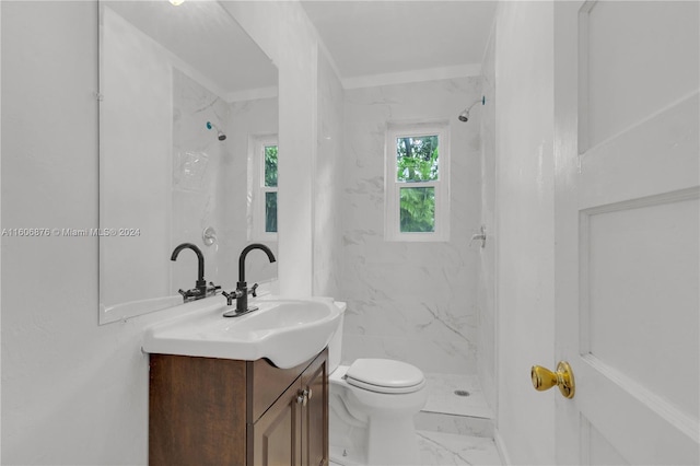 bathroom featuring toilet, a shower, and vanity