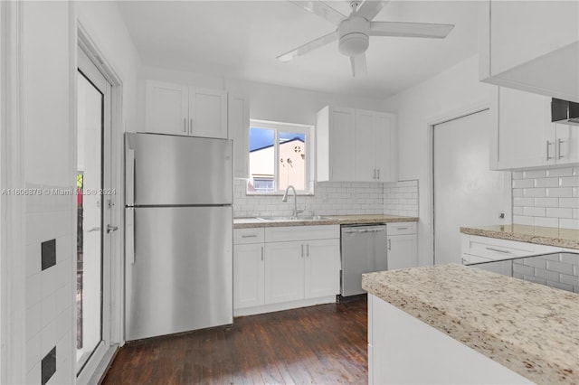 kitchen featuring appliances with stainless steel finishes, white cabinetry, and backsplash