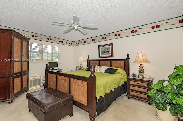 bedroom featuring ceiling fan, light carpet, and a textured ceiling