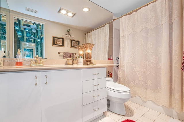 bathroom featuring tile patterned flooring, vanity, and toilet