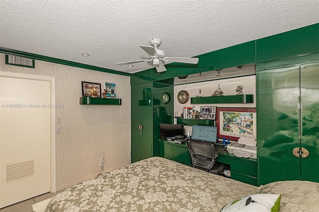 bedroom with a textured ceiling, ceiling fan, and crown molding