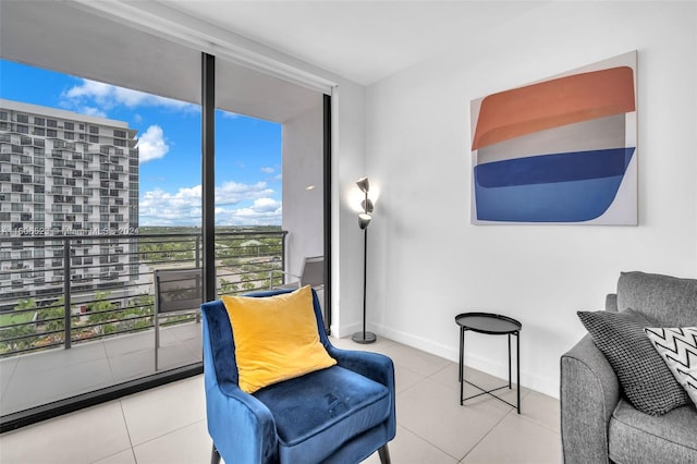 sitting room featuring light tile patterned floors and floor to ceiling windows