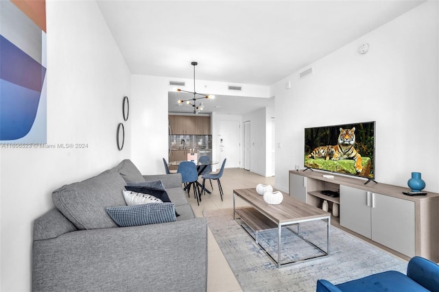 tiled living room featuring a chandelier