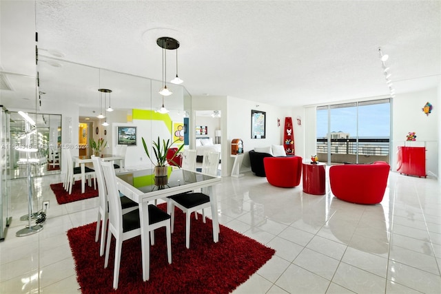 dining room with a textured ceiling and light tile flooring