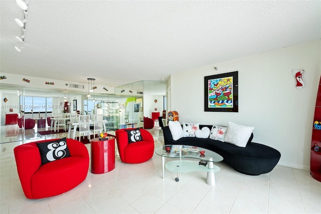 tiled living room featuring a textured ceiling and track lighting