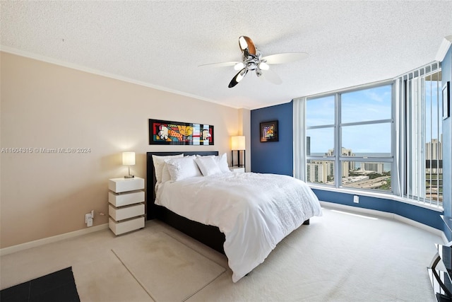 bedroom with a textured ceiling, ornamental molding, carpet, and ceiling fan