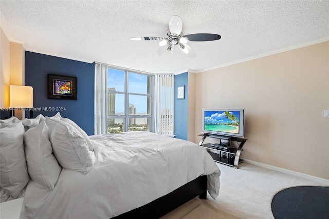 bedroom with carpet flooring, ceiling fan, a textured ceiling, and crown molding