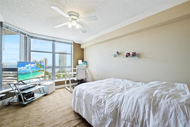 bedroom with crown molding, ceiling fan, a textured ceiling, and light colored carpet