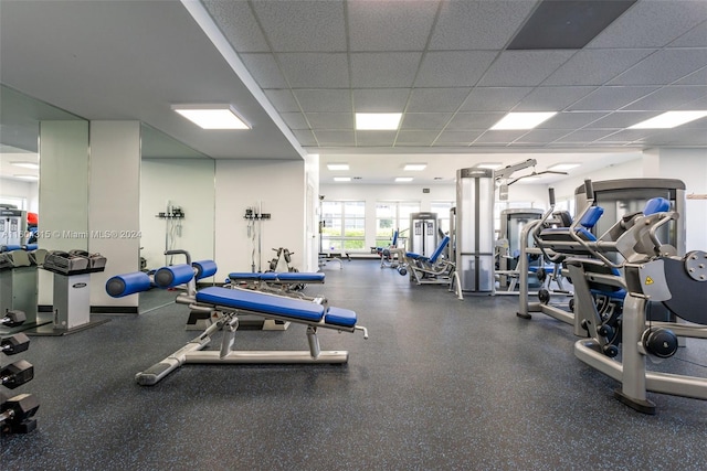 exercise room with a paneled ceiling