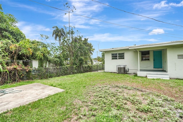 view of yard with a patio area and central air condition unit