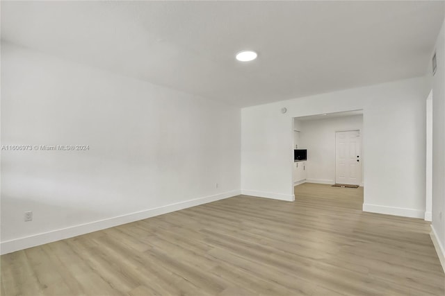 unfurnished room with light wood-type flooring