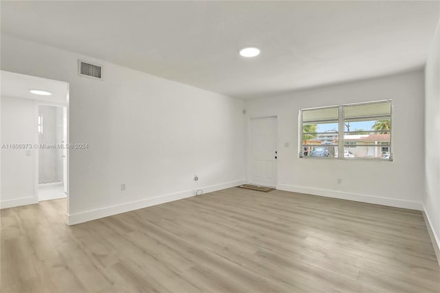 unfurnished room with light wood-type flooring