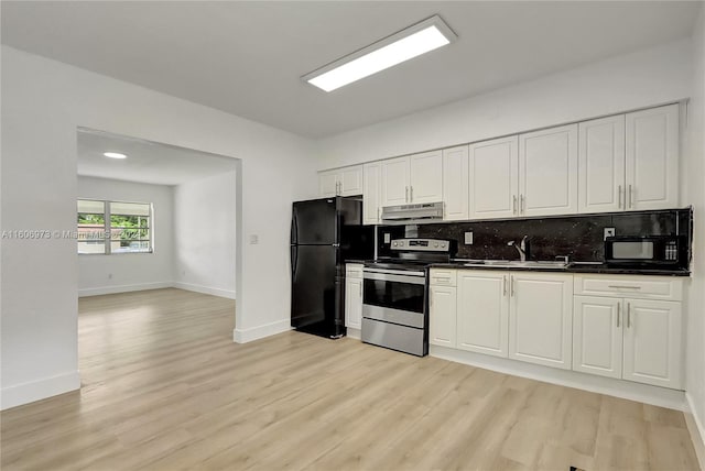 kitchen featuring light hardwood / wood-style flooring, sink, black appliances, and backsplash