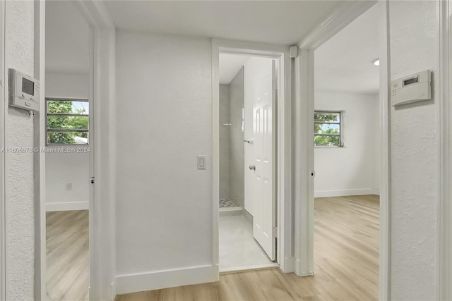 hallway with light hardwood / wood-style floors