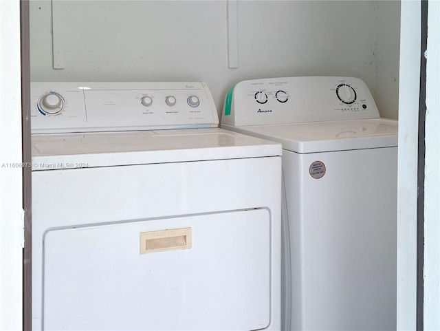 clothes washing area featuring separate washer and dryer